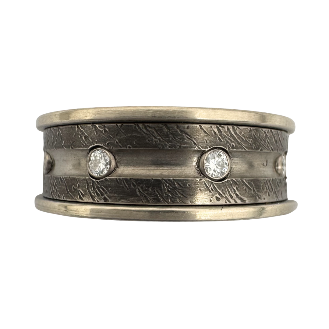 Titanium band with textured surface and gold shoulders. Center channel with (8)2mm diamonds