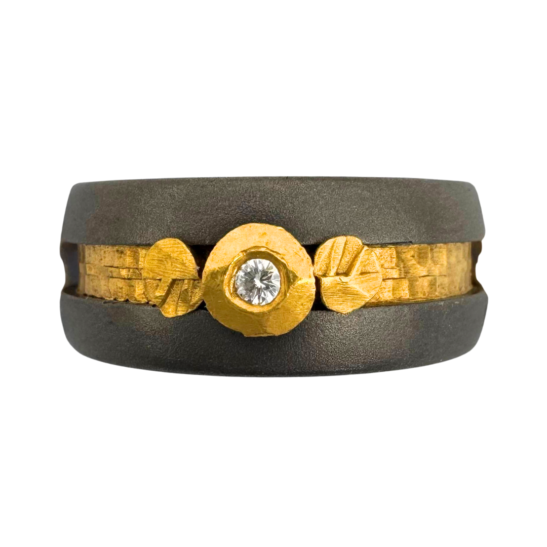 Titanium band with 18K gold setting for (1) 2mm diamond with 24K 'leaves and inlay