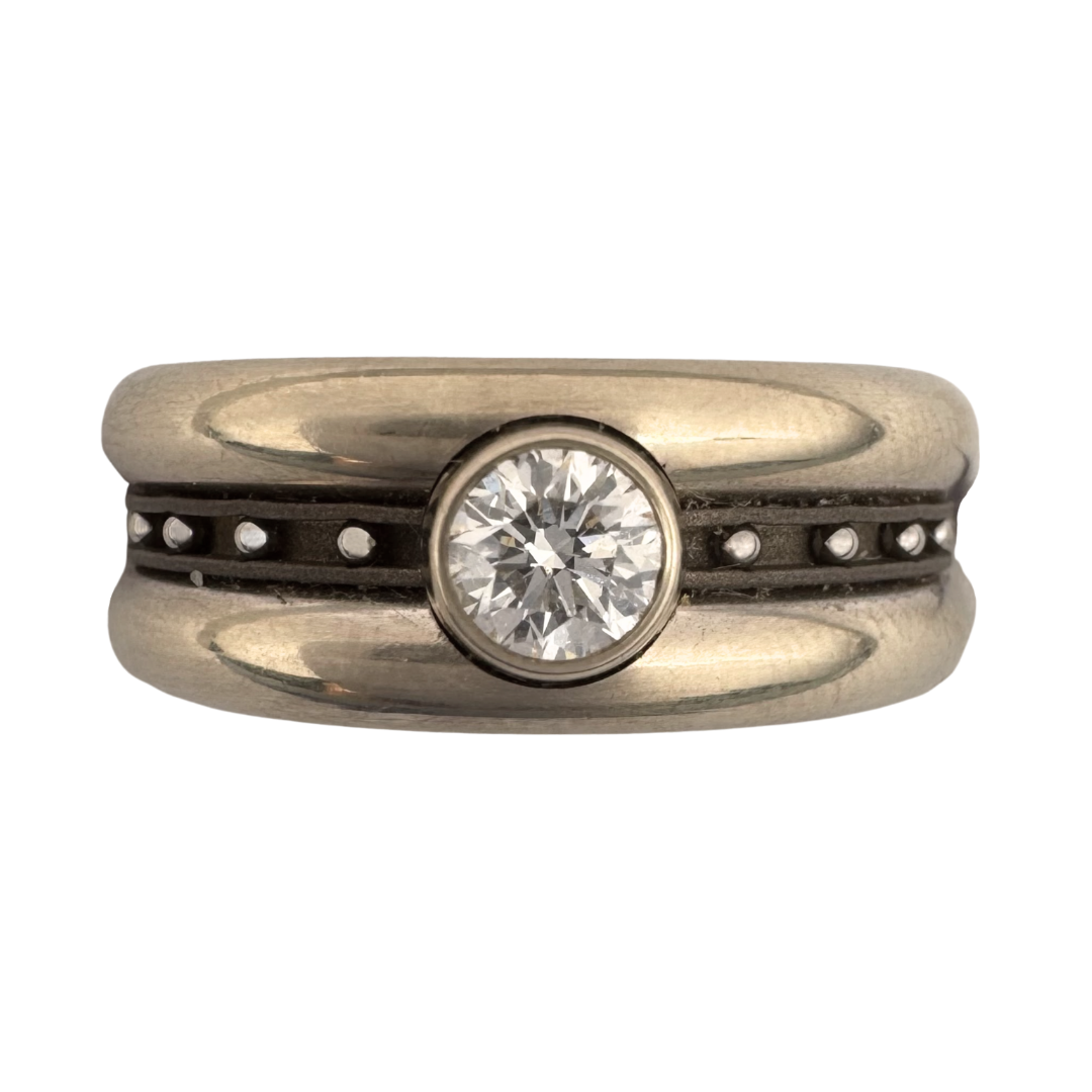 1/4 carat black or white diamond solitaire in 14K white gold set on a titanium liner with (2) 14K white gold bands with stainless steel balls set between them