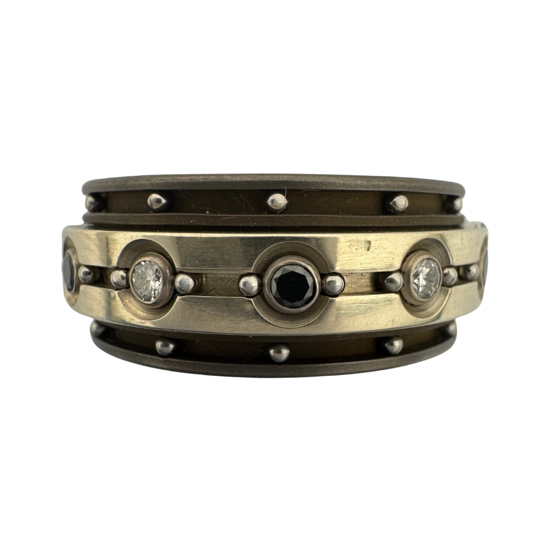 Titanium band with titanium spinner set with 2mm white and black diamonds in 18K gold settings, both bands channeled and with stainless balls