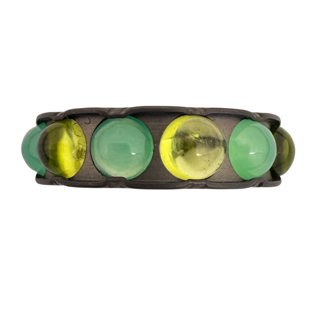 Titanium band set with 5mm peridot and chrysoprase cabochons