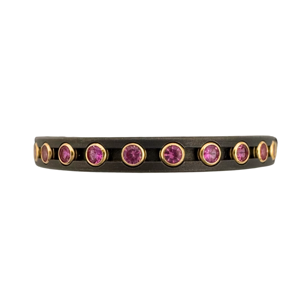 Titanium ring with (24)1.5mm pink sapphire in gold tube settings