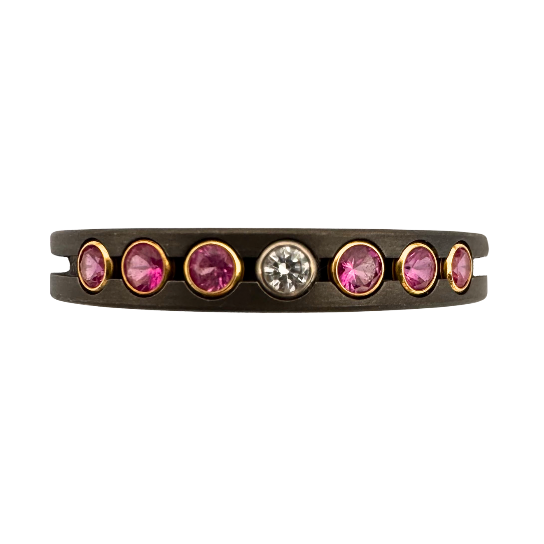 Titanium ring with (6)2mm pink sapphires, (2)2mm diamonds and (4)2mm black spinels in yellow or white gold settings