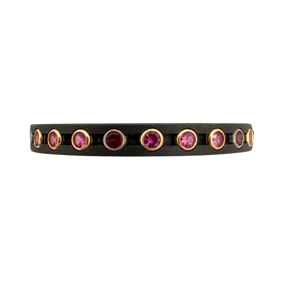 Titanium ring with (6) 1.5mm rubies in white gold and (18) 1.5mm pink sapphires in yellow gold