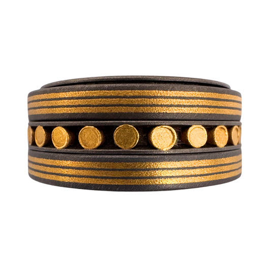 Titanium liner with (3) spinner bands - (2) 3-channel 24K gold pin-stripes and the center band with 24K gold rivets