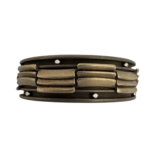Titanium and 14K white gold center band with segmented channels that are laid alternately, with stainless balls