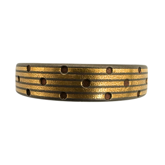 Titanium band with 5-channels inlaid with 24K gold and a punch pattern of copper rivets