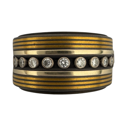 Titanium liner with outside titanium bands pin striped with 24K gold, (2)gold bands and a center band of titanium set with (24)diamonds