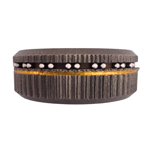 Titanium band with two pattern knurling and an off-center channel inlaid with 24K gold and groups of stainless balls