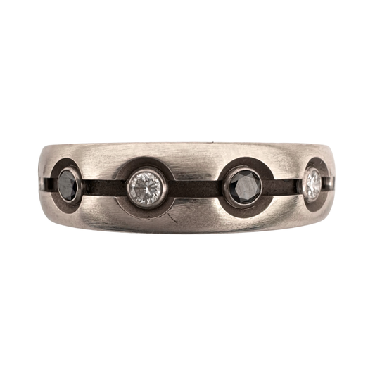 Titanium band with a center channel with (6)2mm black and (6)2mm white diamonds tube set in 18K gold