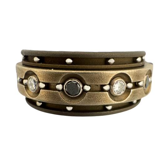 Titanium band with titanium spinner band set with (6)2mm diamonds and (6)2mm blue sapphires in 18K gold tube sets, stainless balls in outer channels