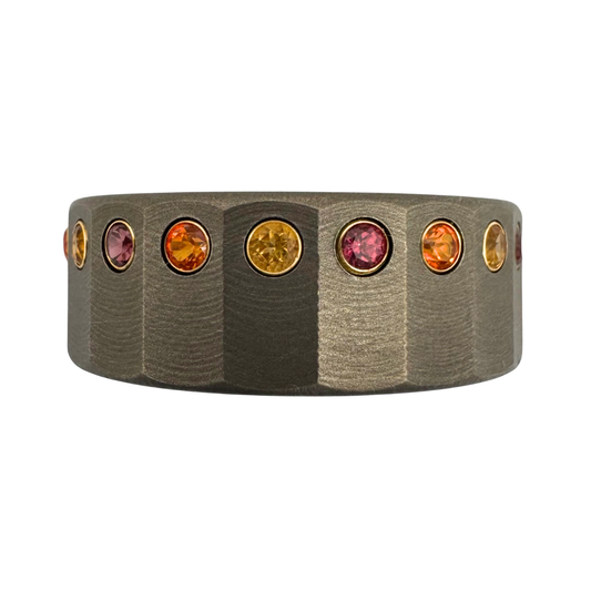 Titanium faceted band with a 2mm citrine, garnet or topaz set in each facet in white gold. Stones could be different