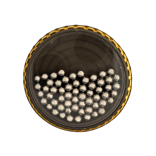 Titanium ring with 2mm stainless balls free-floating under a sapphire crystal, surrounded by 24K gold inlay