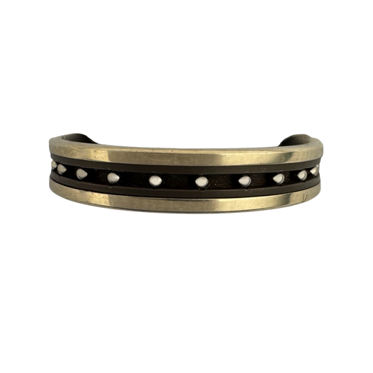 Titanium liner with (2)14K white gold outer bands and stainless balls in the center channel