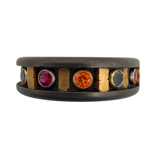 Titanium band with 24K gold rivets and inlays and 2.5mm diamonds, black spinels, rubies and topaz in 18K gold settings