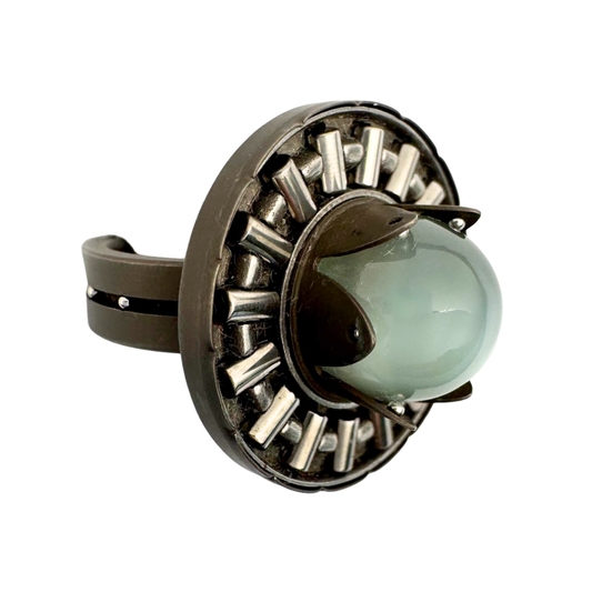 Titanium band with stainless balls with a moonstone tension set with stainless balls on a platform of steel