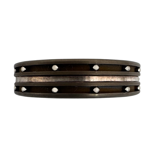 Titanium band with center channel inlaid with pure silver and stainless balls in outside channels