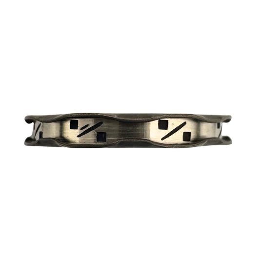 Riffle edged titanium band with punch worked bright-cut channel