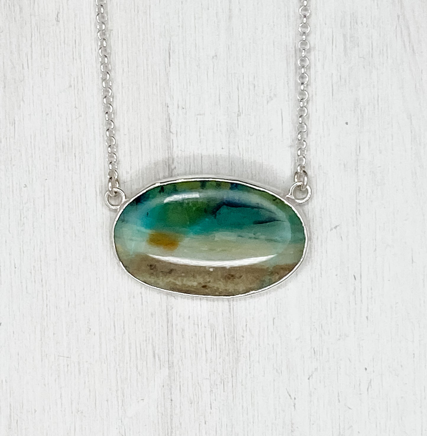 Oval Opalized Wood Pendant with Sun